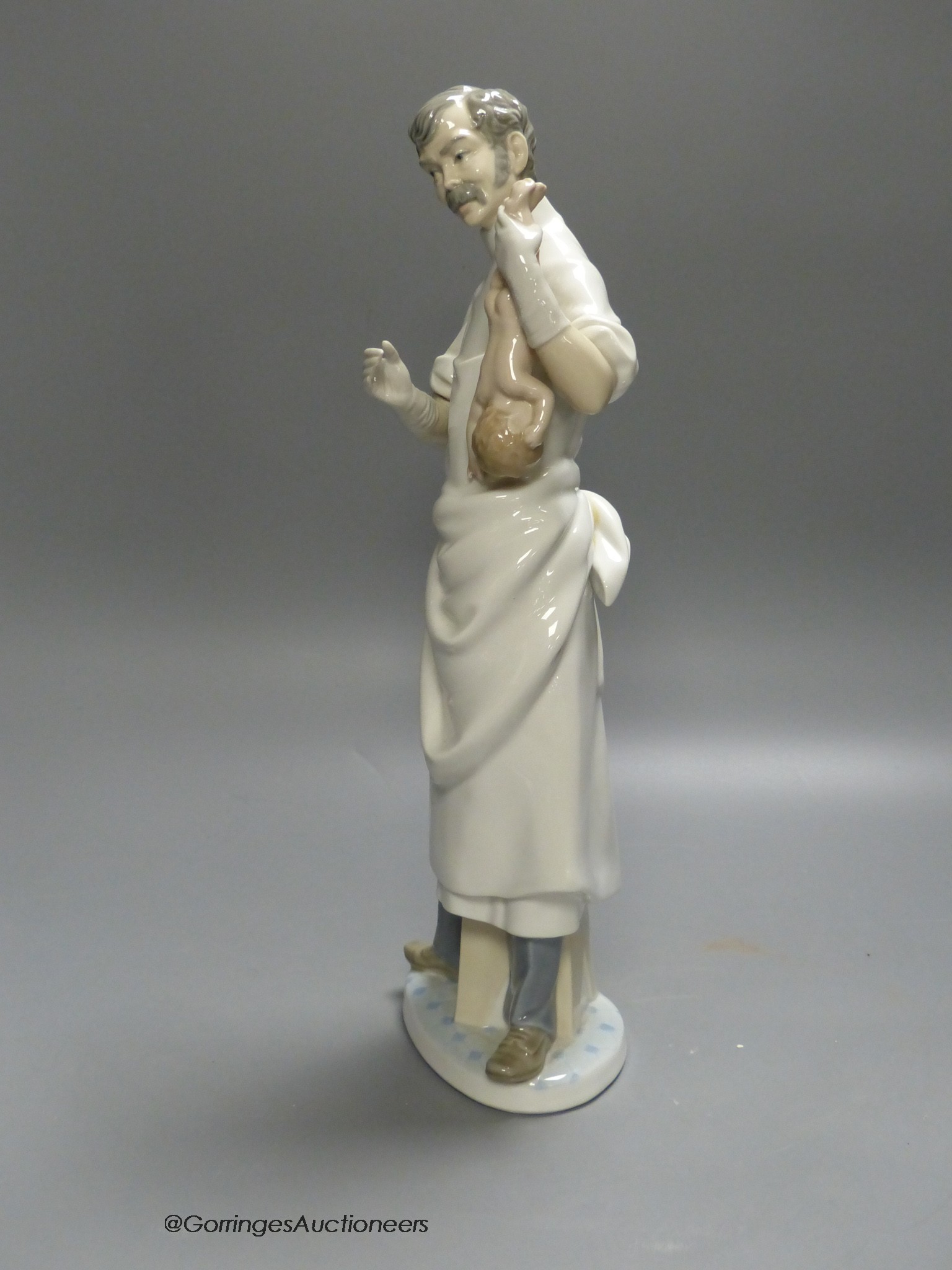 A Lladro figure of a doctor, 36cm high